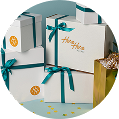Pile of gifts with Here Here Market logo