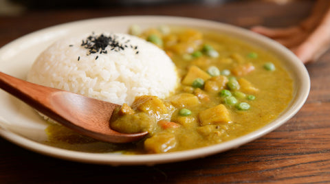 A plant-based curry with potatoes and peas