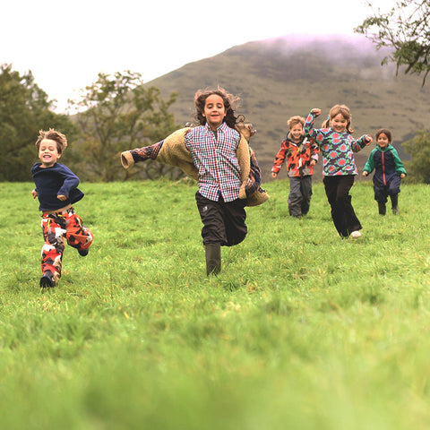 Children running in field during The Den Kit Co. Autumn photoshoot