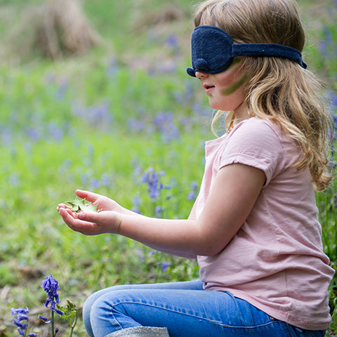 Girl blindfolded whilst playing Prickly Tickly