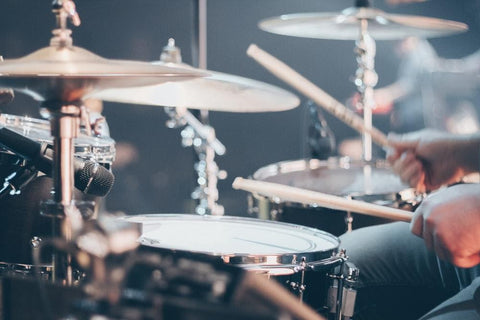 man playing the drums with cymbals