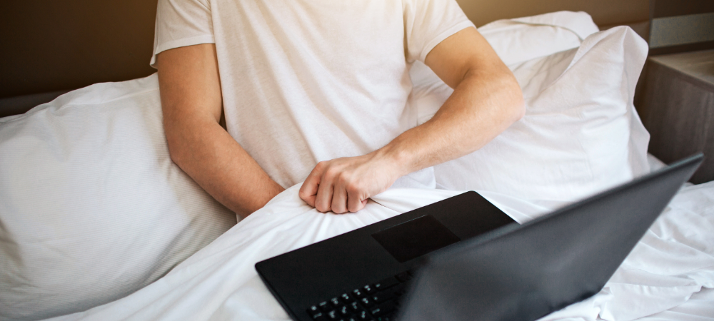 A man in bed with a laptop