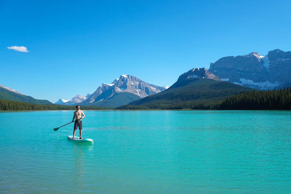 man paddling in lake 