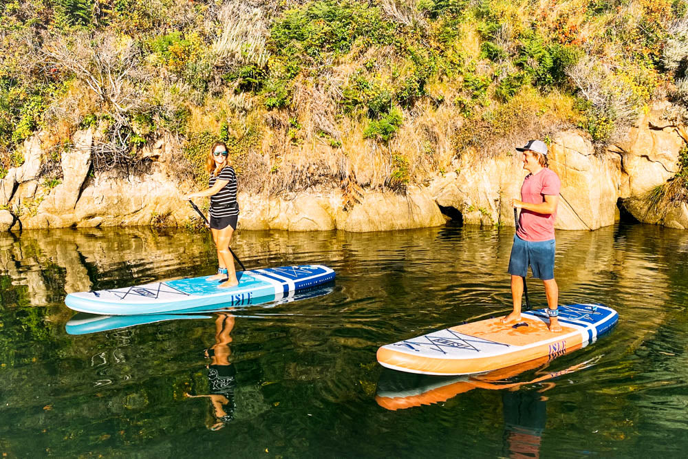 2 people paddling, smiling 