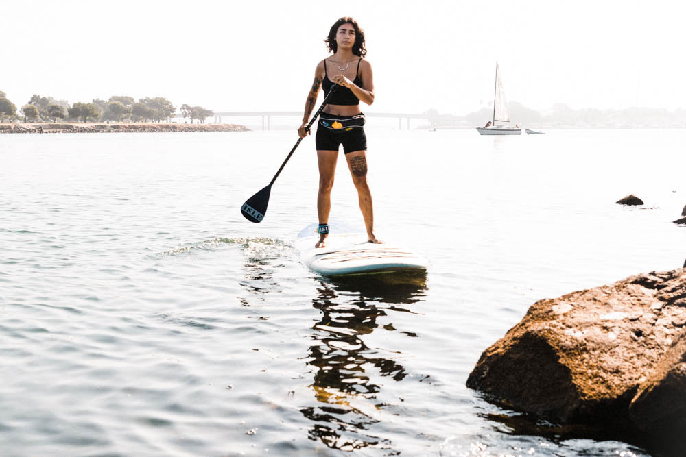woman paddling with a PFD