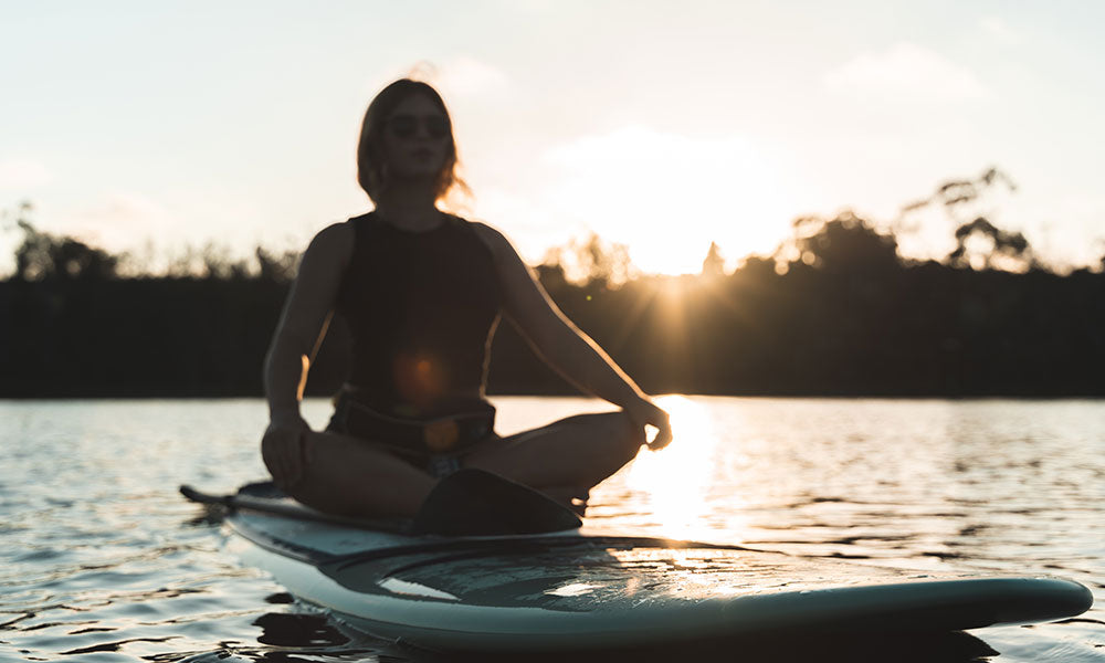 Meditate on paddle boards in water