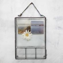 Box Photo Frame with 4 compartments made from glass and metal hanging on a wall
