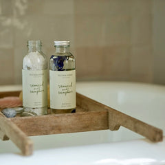 Sustainable bath oils on wooden rack from Wild & Rust