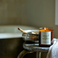 Eco-friendly candle burning with metal dish in background