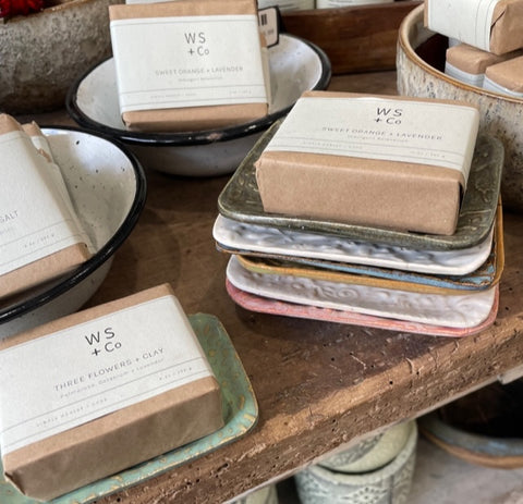 Plastic-free soap bars on ceramic plates at sustainable store in Henley