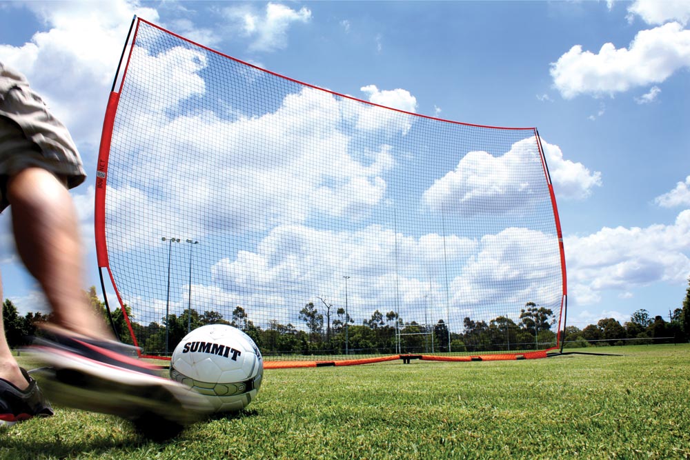 Soccer ball being kicked into a bownet barrier net