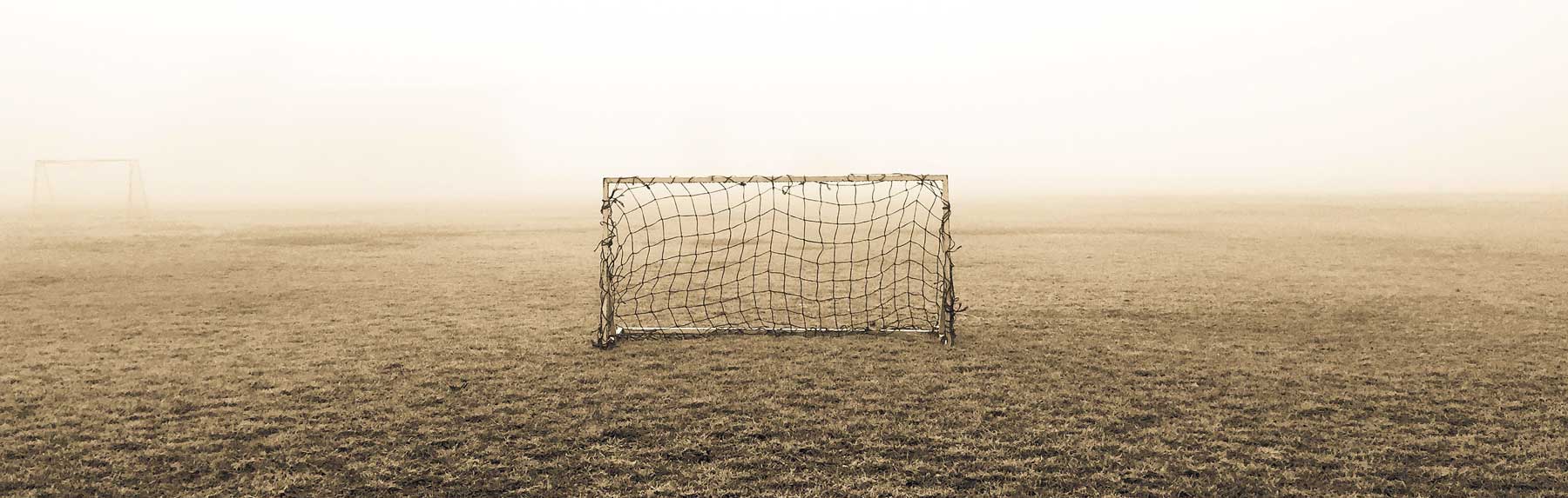 Image of an old and ragged soccer goal