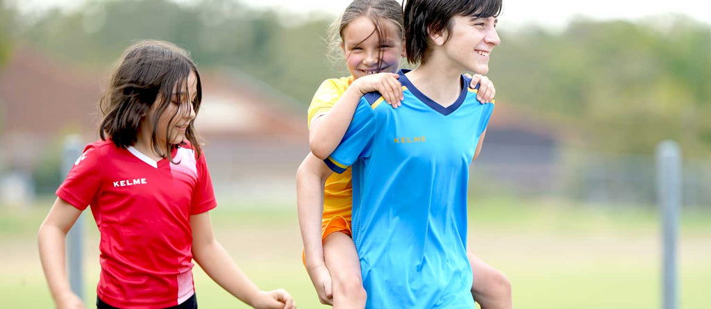 kids playing together in soccer team. Fun football for kids at soccer club. Kelme and SUMMIT soccer range is perfect for kids.