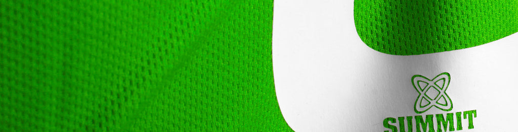 Netball mesh bib close up. C bib material green with white print to show soft material and breathable style of bib.