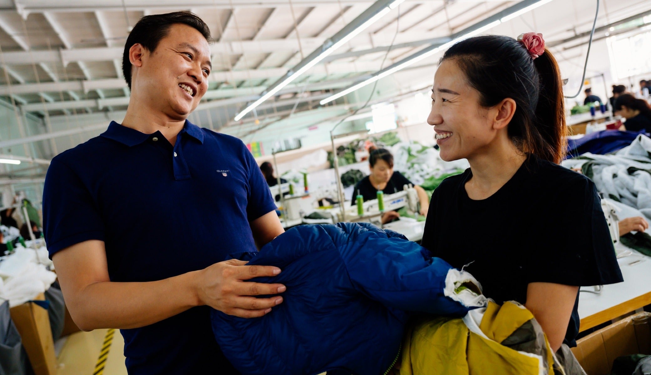Owner George Huang, left, laughs with employee Song Xiao Ying at the factory outside of Tianjin