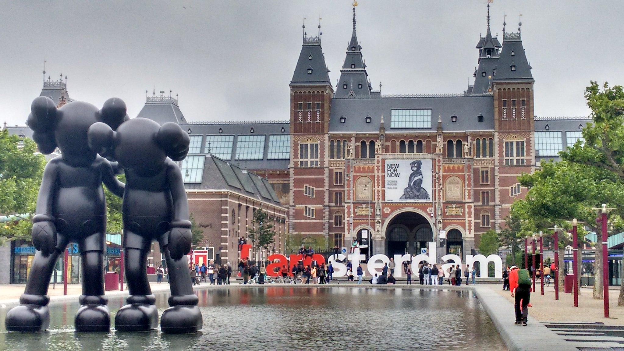 Amsterdam Rijks Museum with statues and tourists