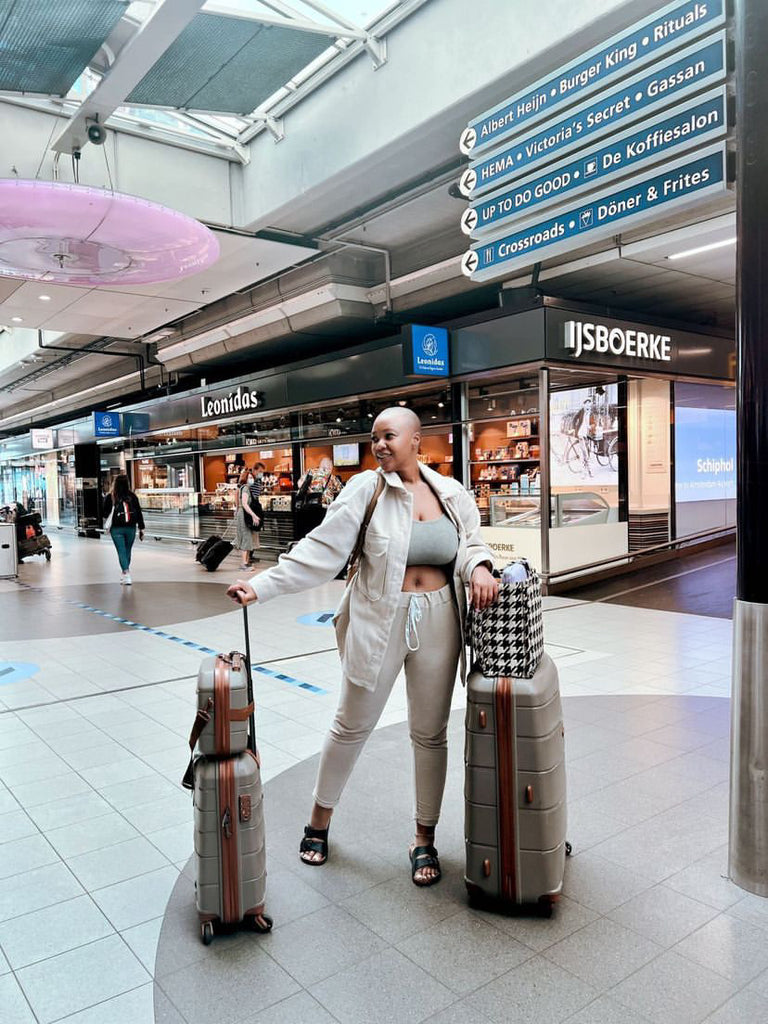 Woman in airport with luxury luggage travel set 
