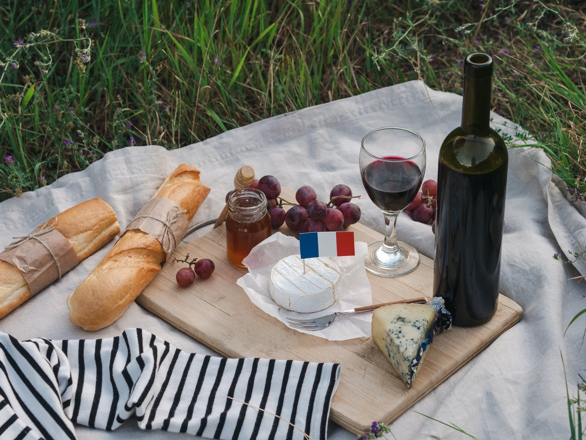 French picnic with wine, cheese, and fresh bread. 