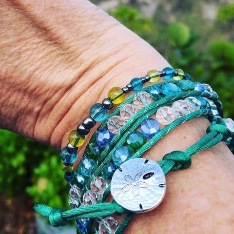 Woman's hand with bracelets made of sea glass
