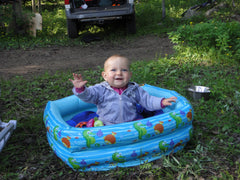 Baby in an inflatable pool without water