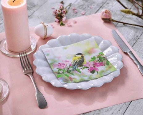 Table setting for wedding or special event. Pink elegant paper napkin with birds.