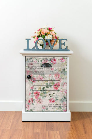 white dresserWhite dresser adorned with pink flower decoupage tissue paper, showcasing a stylish and elegant transformation