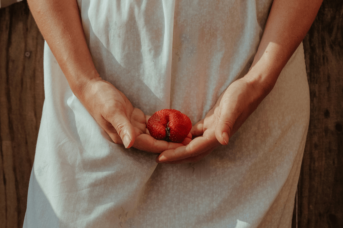 Woman holding strawberry