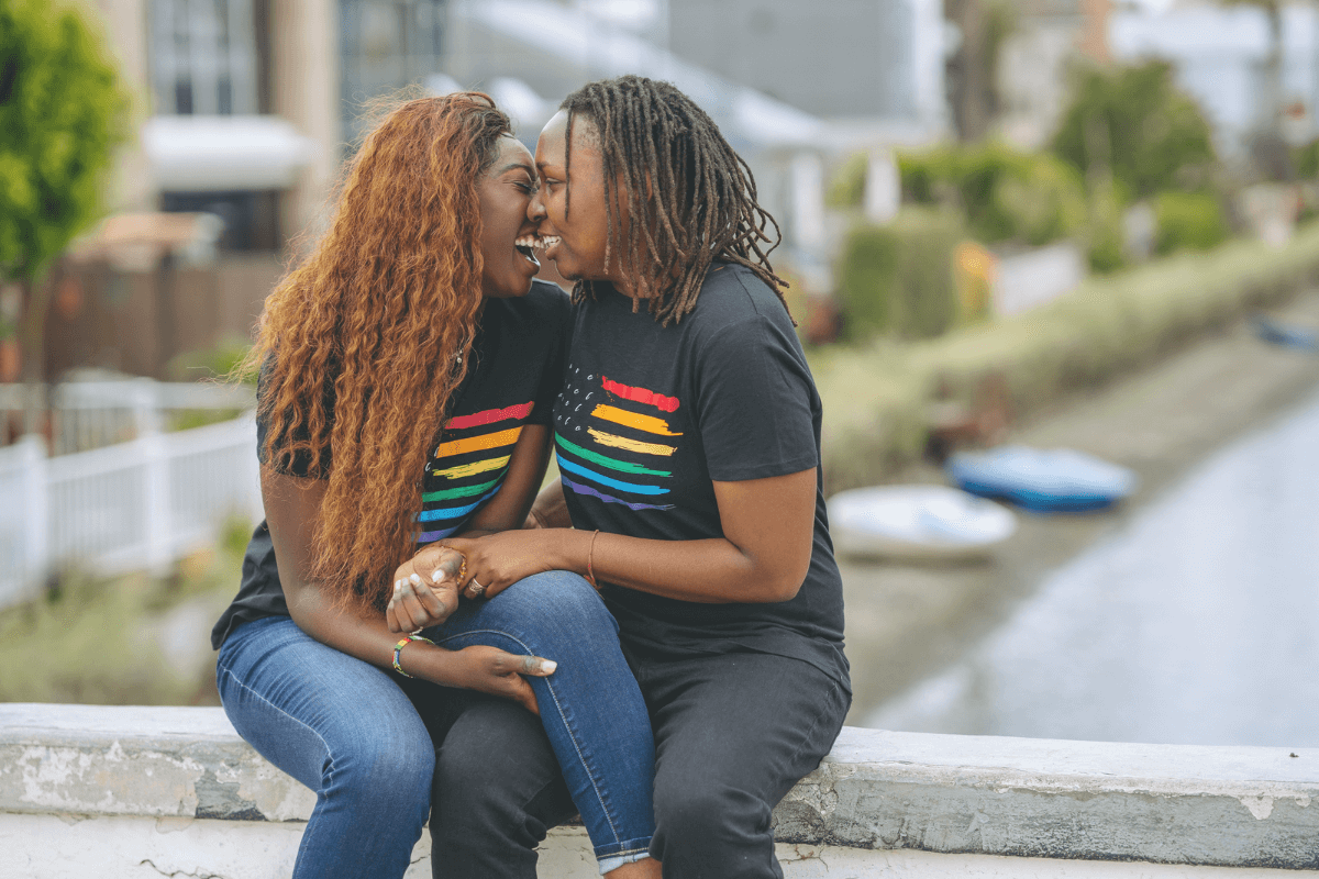 A picture of two women hugging and laughing