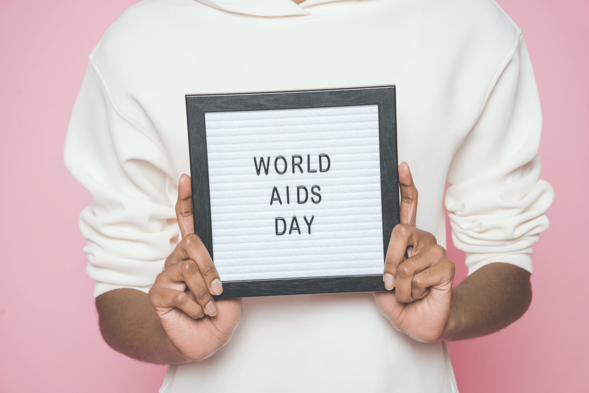 Man holding up a sign that says World AIDS Day
