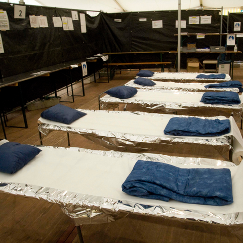 Natural disaster shelter with cots