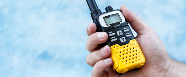 Man Holding a Yellow Walkie Talkie