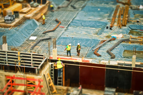 construction site with construction workers wearing PPE
