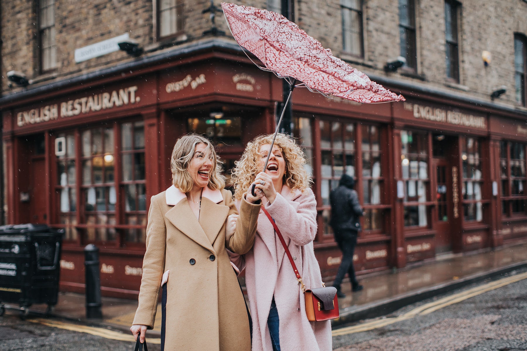 Bloom and Blossom founders walking in the rain with an umbrella