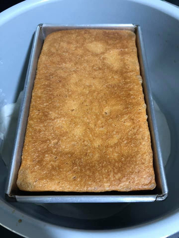 Proofing bread baking in metal tin