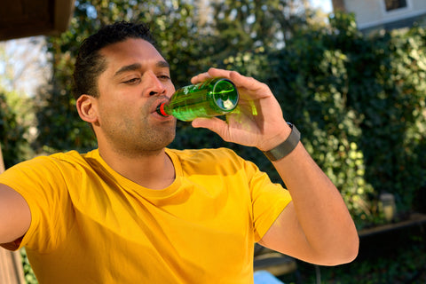 Athlete drinking Mountain Valley Spring Water in glass