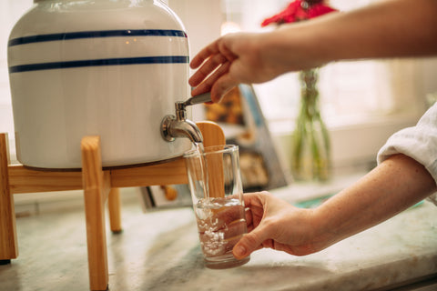 Pouring water from a water dispenser into a glass