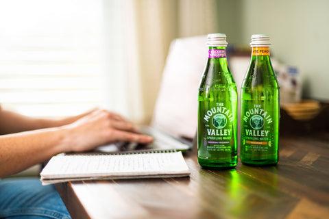 Woman at computer working with Mountain Valley Water