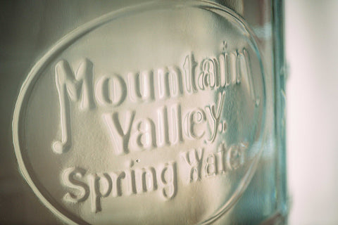 Close up of Mountain Valley Spring Water jug in glass