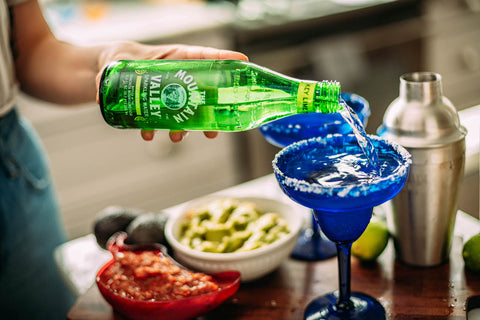 Pouring Mountain Valley Key Lime Twist into a Margarita glass