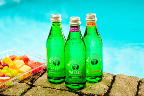 sparkling water bottles by the pool