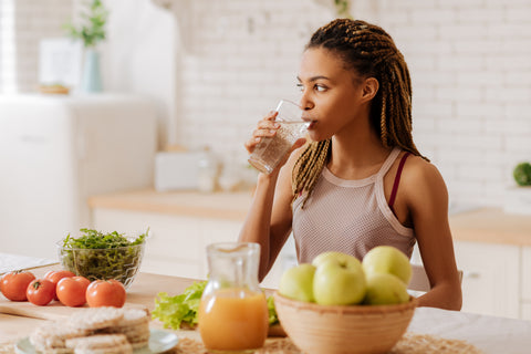 Woman drinking water as part of a healthy lifestyle