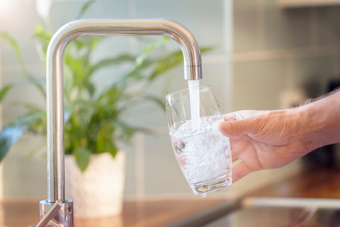 Pouring tap water into a glass