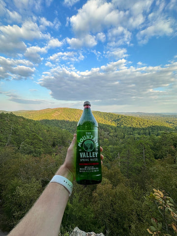 Woman holding Mountain Valley Spring Water in Hot Springs National Park