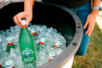 Grabbing Mountain Valley bottle from cooler