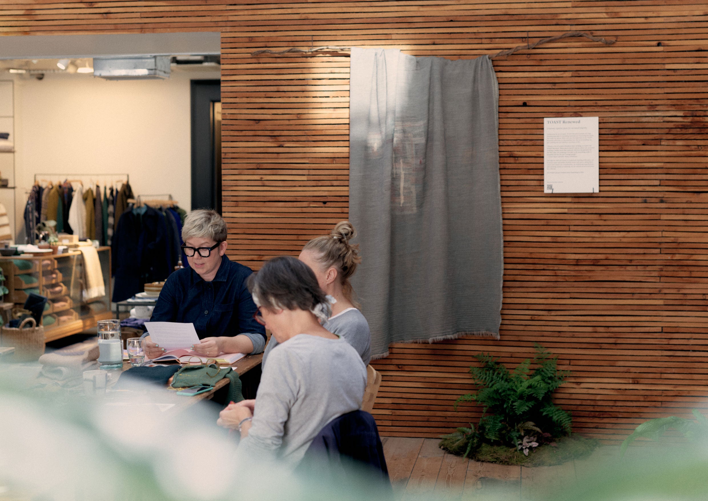 Woman reading to a group around a table