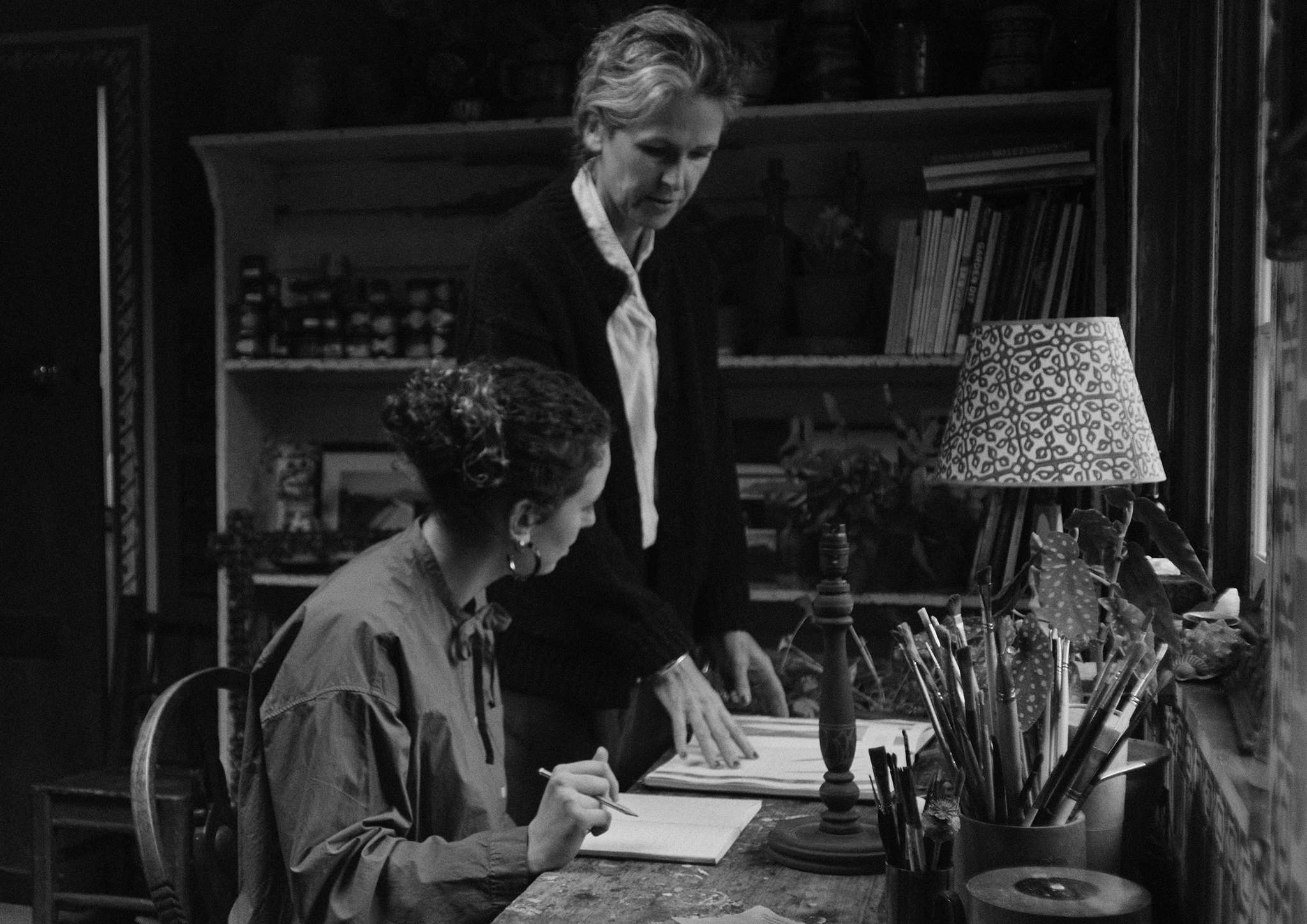 Black and white photograph of two woman at a desk