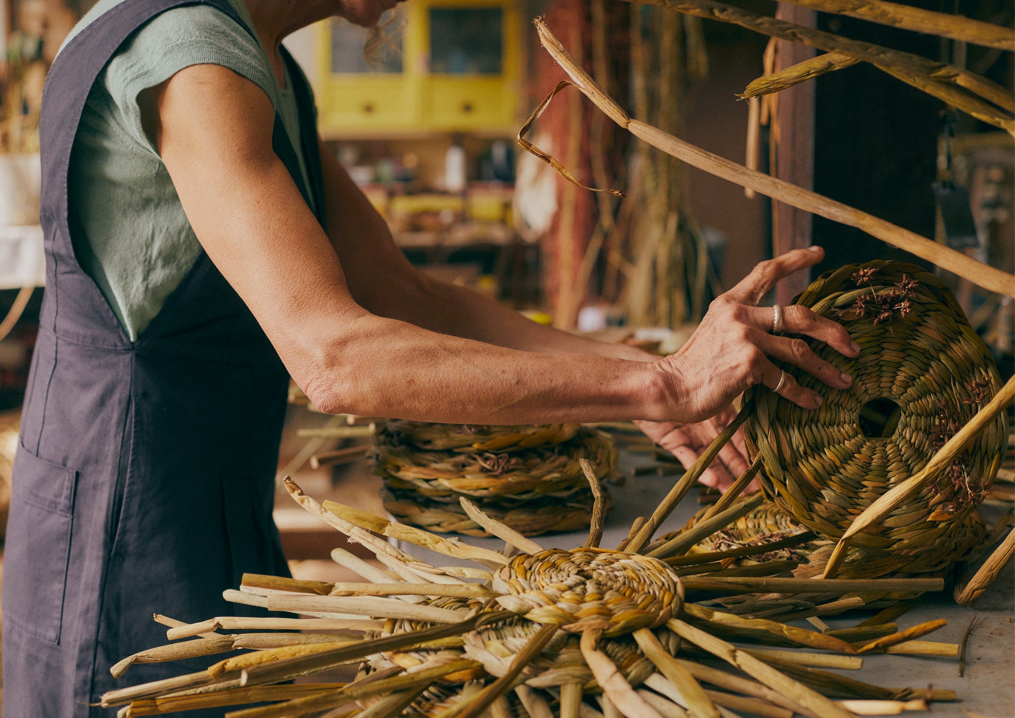 Woman making rush baskets