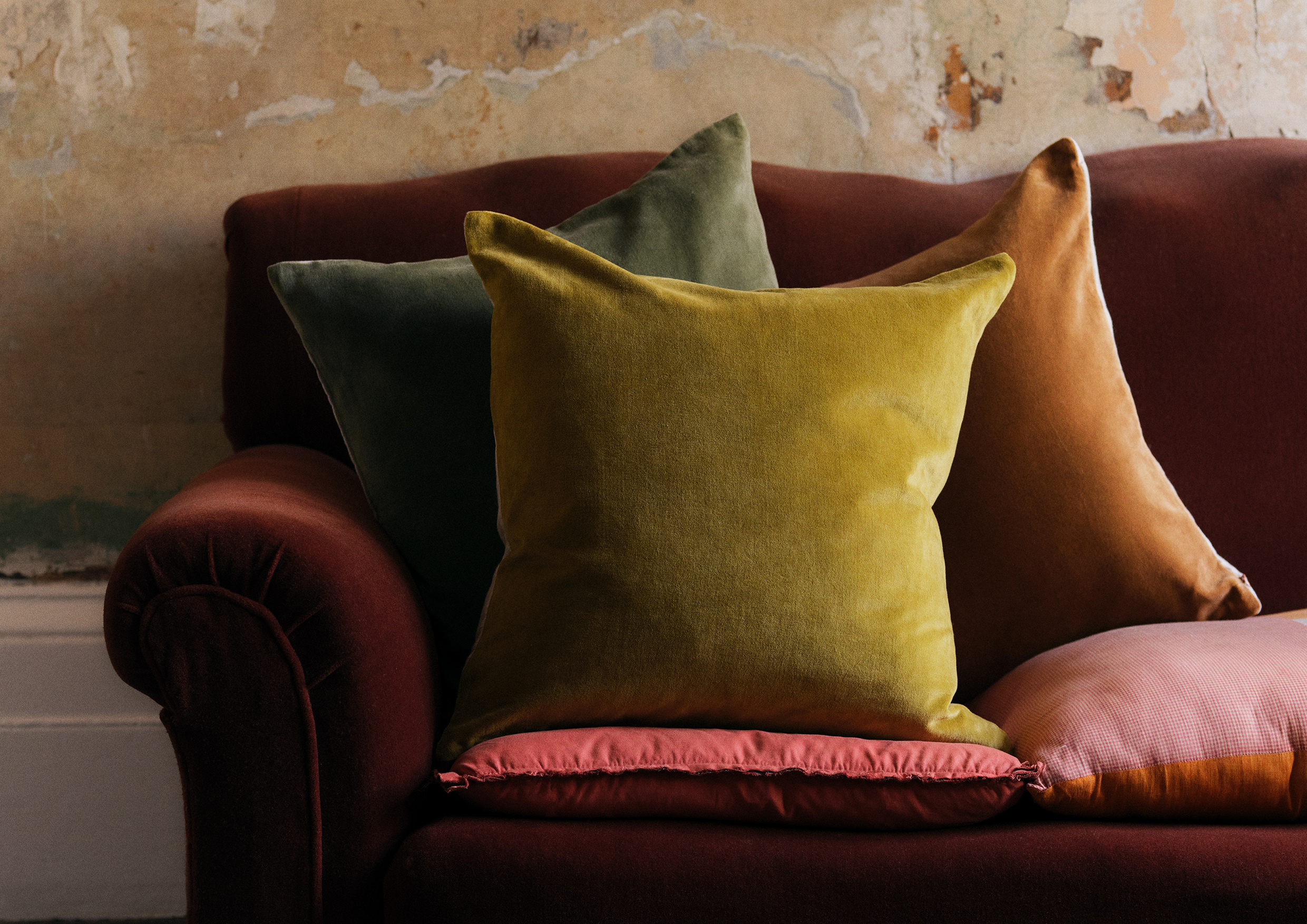 Three cushions on a velvet sofa