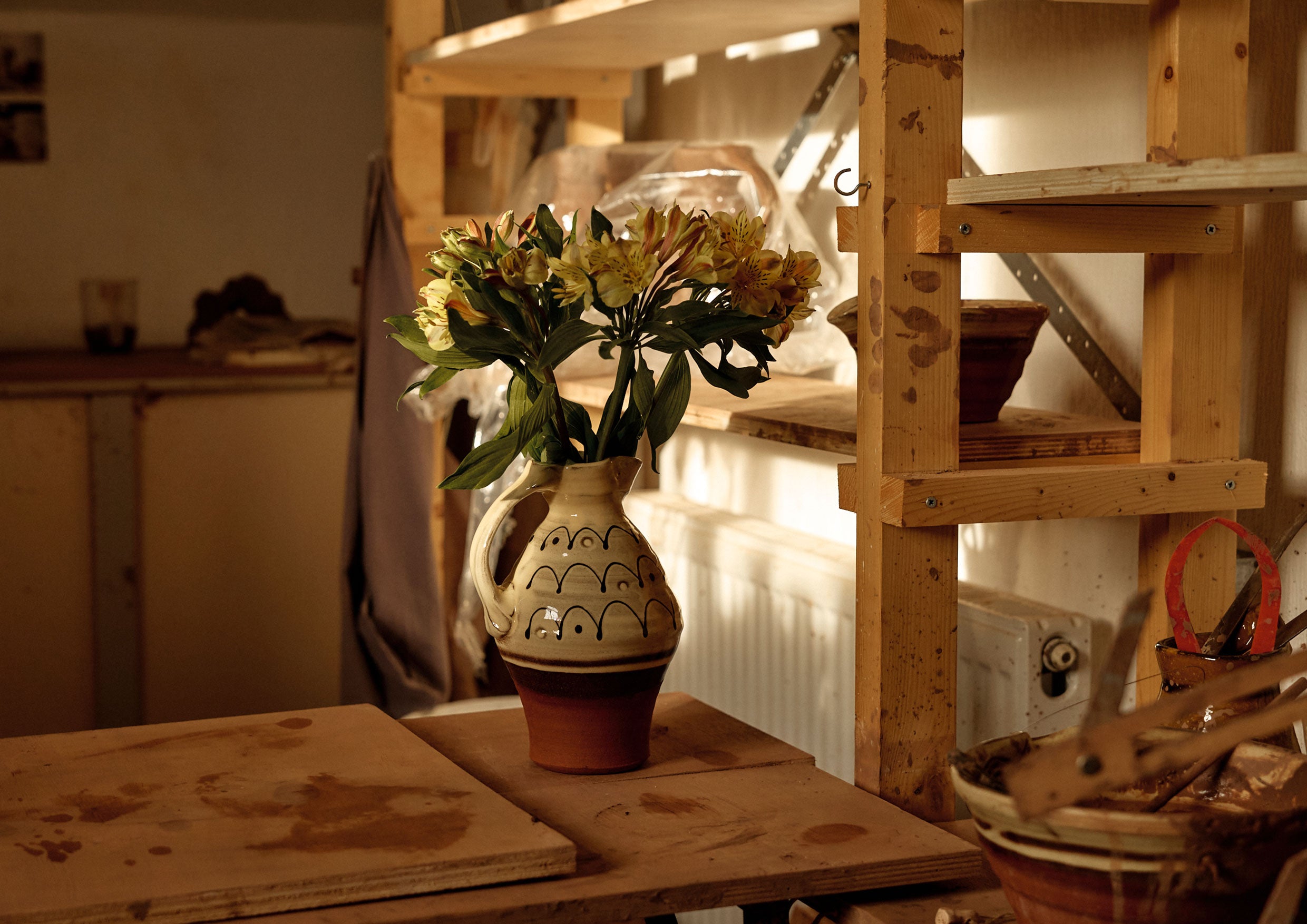 A jug with flowers in.