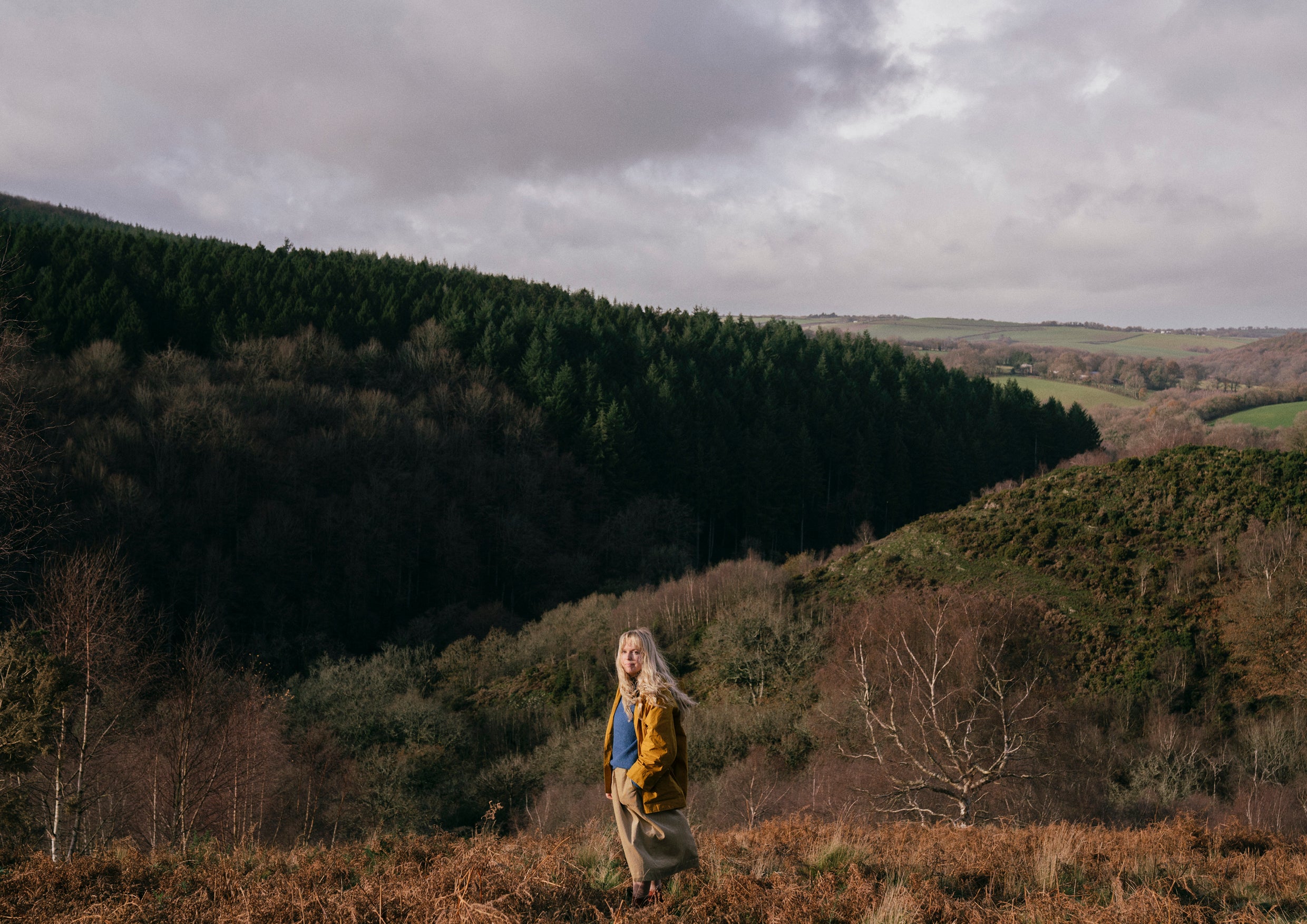 Woman in a yellow coat walking in Dartmoor, Devon